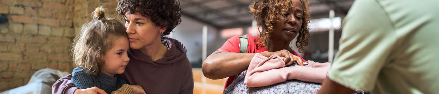 collage featuring women and children at a homeless shelter. Woman on the left is hugging her young daughter; woman on the right is receiving blankets from a community worker.